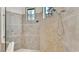 Custom walk-in shower with two shower heads and decorative tile surround at 6942 Indian Creek Park Dr, Lakeland, FL 33813