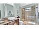 Modern bathroom with a glass enclosed shower, marble counter tops, and bright lighting at 6942 Indian Creek Park Dr, Lakeland, FL 33813