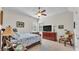 Cozy bedroom featuring a ceiling fan, large windows, and a vintage chair at 6942 Indian Creek Park Dr, Lakeland, FL 33813