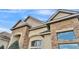 Exterior architectural detail showcasing stone accents, stucco siding, and a multi-gable roofline at 6942 Indian Creek Park Dr, Lakeland, FL 33813