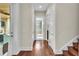 Bright hallway with hardwood floors leading to a bathroom with a glass shower at 6942 Indian Creek Park Dr, Lakeland, FL 33813