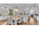 Open kitchen and dining area featuring white cabinetry, granite countertops, and modern lighting at 6942 Indian Creek Park Dr, Lakeland, FL 33813