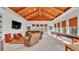 Spacious living room with a distinctive orange ceiling, comfortable seating, and a shuffleboard table at 6942 Indian Creek Park Dr, Lakeland, FL 33813