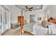 Main bedroom featuring a four-poster bed, soft carpet, a tray ceiling, and ample space for furniture at 6942 Indian Creek Park Dr, Lakeland, FL 33813