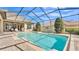 A view of the pool and patio from under the screened-in enclosure at 6942 Indian Creek Park Dr, Lakeland, FL 33813