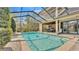 Beautiful screened-in pool with patio and nearby covered outdoor seating at 6942 Indian Creek Park Dr, Lakeland, FL 33813