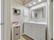 Well-lit bathroom with marble counter tops, custom vanity, and wood floors at 720 Lake Jessie Dr, Winter Haven, FL 33881