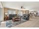 Bright living room featuring comfortable sofas, tile flooring, and an open floor plan connected to dining area at 720 Lake Jessie Dr, Winter Haven, FL 33881