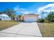 Charming single-story home features a two-car garage, ample driveway space, and well-maintained front yard at 736 Hunt Dr, Lake Wales, FL 33853