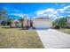 Charming single-story home features a two-car garage and well-maintained front yard at 736 Hunt Dr, Lake Wales, FL 33853