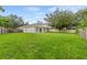 Expansive grassy backyard enclosed by a wooden fence, providing a serene outdoor space at 7444 Hunters Greene Cir, Lakeland, FL 33810