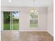 Cozy dining area featuring tile flooring, a sliding glass door to the backyard, and a chandelier at 7444 Hunters Greene Cir, Lakeland, FL 33810