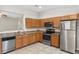 Functional kitchen featuring stainless steel appliances, granite counters, and wood cabinetry at 7444 Hunters Greene Cir, Lakeland, FL 33810