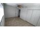 A bright bedroom offers tile floors and a closet with sliding doors for storage at 745 4Th St, Polk City, FL 33868