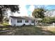 A charming single-story house with a fenced yard and well-maintained lawn at 745 4Th St, Polk City, FL 33868