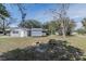 Home with a large backyard, outdoor storage shed, and a fire pit at 808 Spirit Lake Rd, Winter Haven, FL 33880