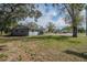 Backyard of a home with mature trees, a shed, and ample space at 808 Spirit Lake Rd, Winter Haven, FL 33880