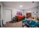 Bright bedroom with playful decor and carpet flooring with a bed and shelving at 808 Spirit Lake Rd, Winter Haven, FL 33880