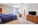 Neutral primary bedroom featuring natural light and a functional layout with a dresser at 808 Spirit Lake Rd, Winter Haven, FL 33880