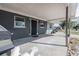 A covered front porch featuring durable concrete flooring and a view of the surrounding neighborhood at 808 Spirit Lake Rd, Winter Haven, FL 33880