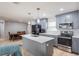 Modern kitchen with sleek gray cabinetry, quartz countertops, and stainless steel appliances at 808 Spirit Lake Rd, Winter Haven, FL 33880