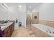 Bathroom features double vanity, granite counters, walk-in shower, and soaking tub at 824 Ulmer Rd, Frostproof, FL 33843