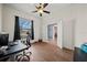 Another bedroom with a ceiling fan, great natural light, and hardwood floors at 824 Ulmer Rd, Frostproof, FL 33843