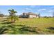 Well-maintained home exterior with a lush lawn and mature landscaping at 824 Ulmer Rd, Frostproof, FL 33843