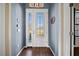 Welcoming foyer with decorative glass door and hardwood floors at 824 Ulmer Rd, Frostproof, FL 33843