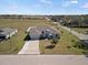 Aerial front exterior view of a single-Gathering home with a two car garage and front yard at 824 Ulmer Rd, Frostproof, FL 33843