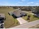 Aerial front exterior view of a single-Gathering home with a long driveway and manicured lawn at 824 Ulmer Rd, Frostproof, FL 33843