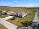 Aerial front exterior view of a single-Gathering home with a two car garage and front yard at 824 Ulmer Rd, Frostproof, FL 33843