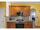 Close up of kitchen with granite counters, stainless steel appliances and wood cabinets at 824 Ulmer Rd, Frostproof, FL 33843