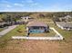 Back exterior view of a home with a screened lanai pool and a fenced yard at 824 Ulmer Rd, Frostproof, FL 33843