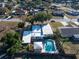 Aerial view of home with a pool and fenced yard in a residential area with mature trees at 827 Sherwood Dr, Lake Wales, FL 33898