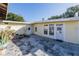 Backyard patio area showing multiple points of entry into the home with ample lighting and potential at 827 Sherwood Dr, Lake Wales, FL 33898