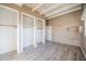 Bright bedroom with hardwood-style flooring, exposed beam ceiling, and multiple closets at 827 Sherwood Dr, Lake Wales, FL 33898