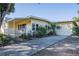 Charming home featuring a delightful front porch, mature landscaping, and a two-car garage at 827 Sherwood Dr, Lake Wales, FL 33898