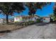 Welcoming single-story home with a covered porch, double front doors, and a paved driveway at 827 Sherwood Dr, Lake Wales, FL 33898