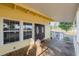 View of the covered front porch with double entry doors and white railings, offering a welcoming entrance at 827 Sherwood Dr, Lake Wales, FL 33898