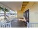 Inviting covered front porch featuring wood flooring, white railings, and double front doors at 827 Sherwood Dr, Lake Wales, FL 33898