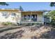 Inviting home with a covered front porch and decorative lattice trim at 827 Sherwood Dr, Lake Wales, FL 33898