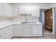 Bright kitchen featuring white cabinets, a stainless steel sink, and modern appliances at 827 Sherwood Dr, Lake Wales, FL 33898