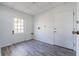 Well-lit laundry room with tile flooring, a utility sink, and ample storage space at 827 Sherwood Dr, Lake Wales, FL 33898