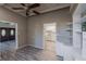 Open-concept featuring gray flooring, stylish shelving, and views into the kitchen at 827 Sherwood Dr, Lake Wales, FL 33898