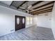 Bright living room featuring beamed ceiling, gray flooring and natural light from windows near the entry at 827 Sherwood Dr, Lake Wales, FL 33898