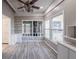 Cozy living room featuring gray flooring, bright windows, and stylish built-in shelving at 827 Sherwood Dr, Lake Wales, FL 33898