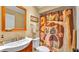 Bathroom with a sink, toilet, mirror, and a shower with an decorative owl patterned shower curtain at 860 Lila St, Bartow, FL 33830