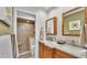 Bathroom features double sinks, granite countertops, wood cabinetry, and a tiled glass-door shower at 860 Lila St, Bartow, FL 33830