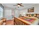 Comfortable bedroom featuring wood floors, ceiling fan, a closet, and a side table with a lamp at 860 Lila St, Bartow, FL 33830